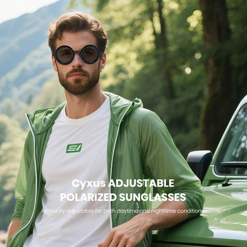 Man wearing Cyxus adjustable polarized sunglasses with a green jacket and white shirt in a forest setting.